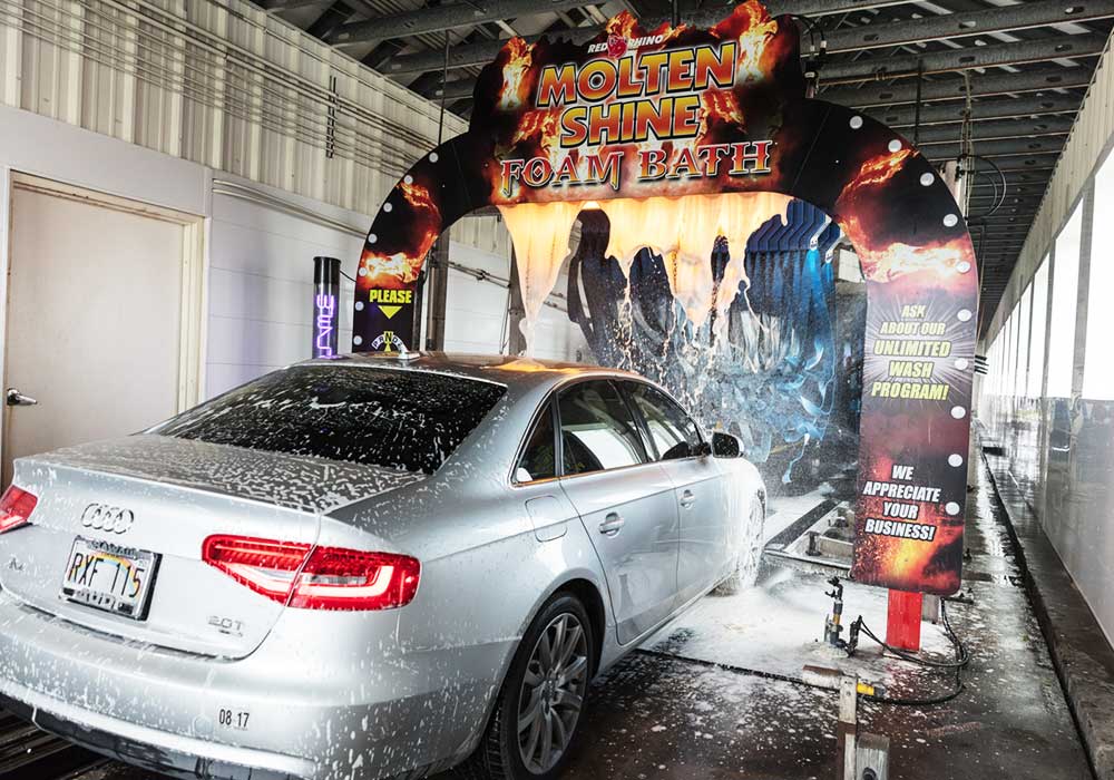 silver car entering car wash